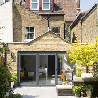 house exterior with glass door and bricked wall