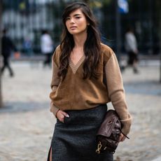 milan spring 2026 fashion week attendee wearing brown v-neck sweater