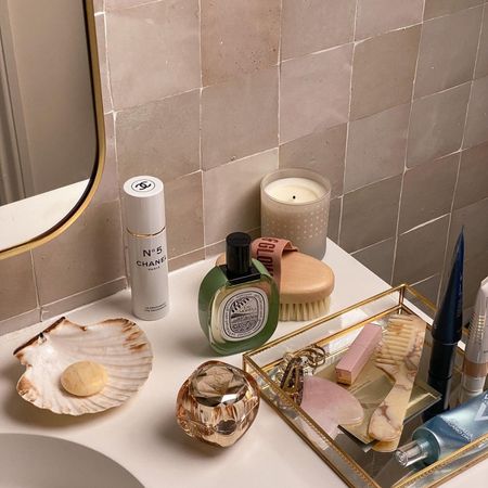 @emmahoareau bathroom side with skincare and a gua sha