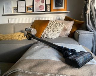 Proscenic P11 Smart vacuum cleaner in full on sofa