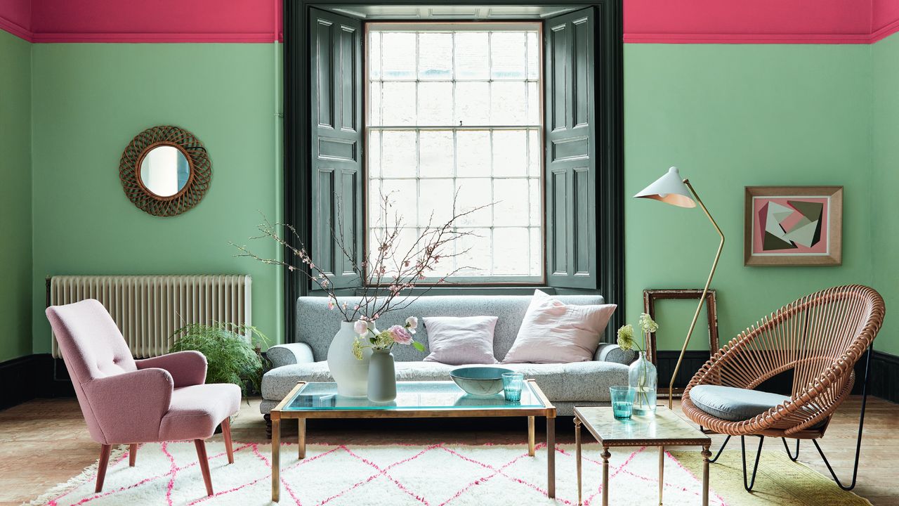 Living room with green and pink walls and grey sofa