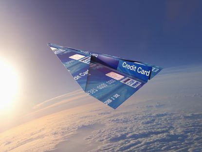 An illustrated image of a paper airplane made out of a credit card flying through the clouds 