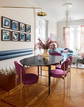 A colorful dining area with purple chairs and a bespoke bench