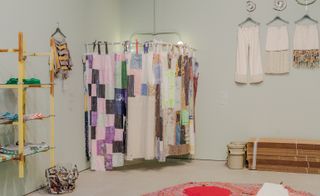 Exhibition view of Possessed featuring a patchwork hanging divider