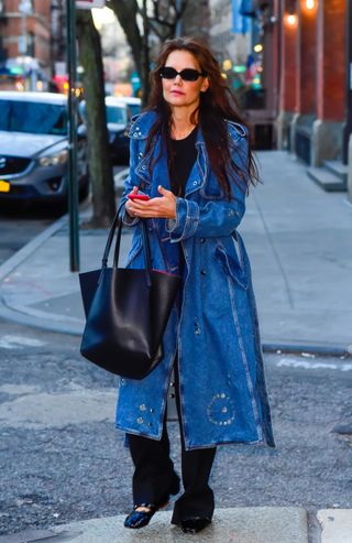 Katie Holmes wears a denim trench coat while walking around New York City