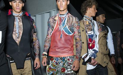 Male models wearing tattoo sleeves as part of the collection