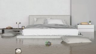 A bedroom filled with water with bedroom items floating around