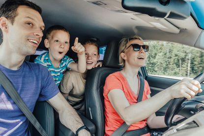 Family on holiday travelling in hire car