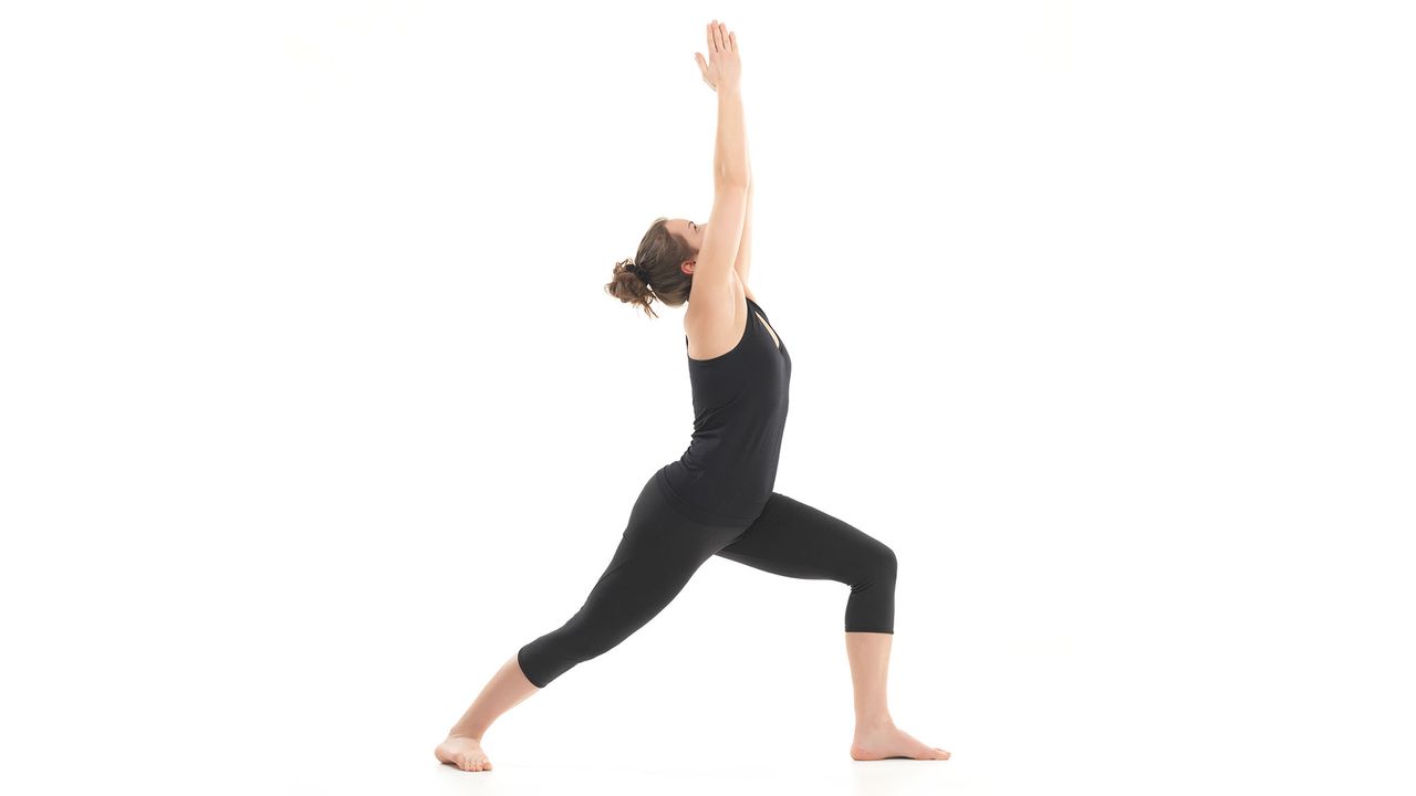Woman doing Warrior One yoga pose