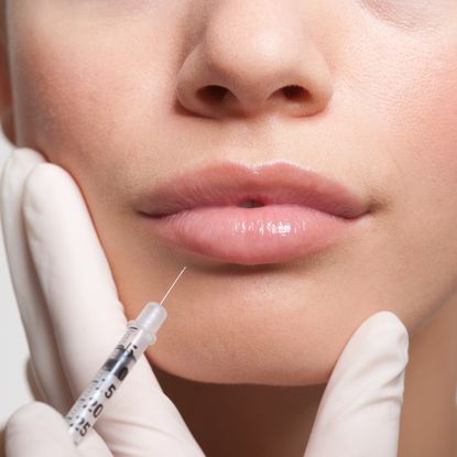 woman getting lip injection in her face