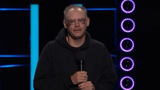 Tim Sweeney on stage in a black jacket