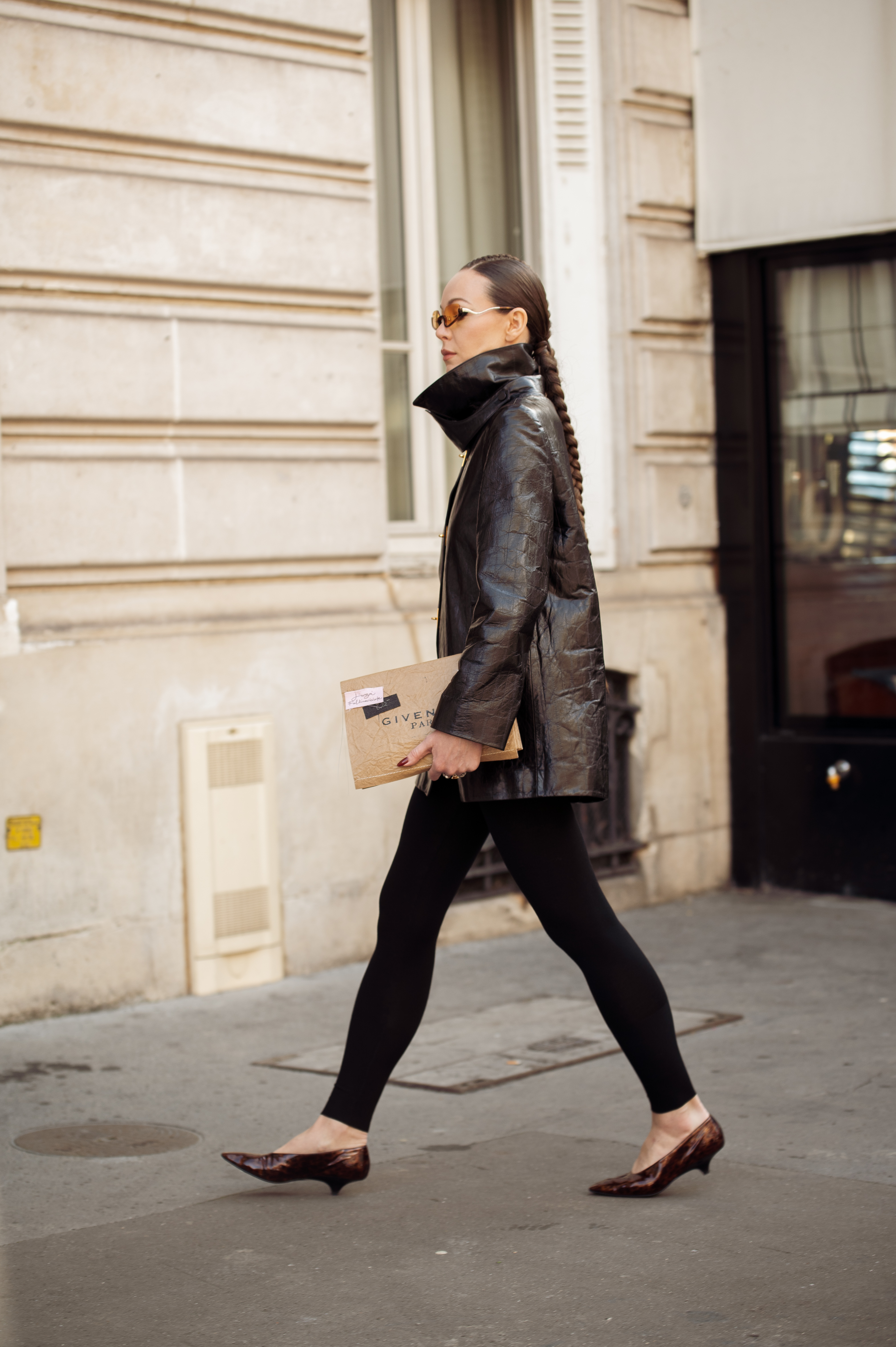 PARIS, FRANCE - MARCH 11: Erika Boldrin wears black Miu Miu ballerinas, black skinny trousers, a black leather Miu Miu bag, a grey trench, a blue sweater and brown sunglasses outside Miu Miu during the Womenswear Fall/Winter 2025/2026 as part of Paris Fashion Week on March 11, 2025 in Paris, France. (Photo by Valentina Frugiuele/Getty Images)