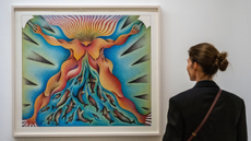 A visitor looks at a painting during the preview of Judy Chicago: Revelations at Serpentine North Gallery