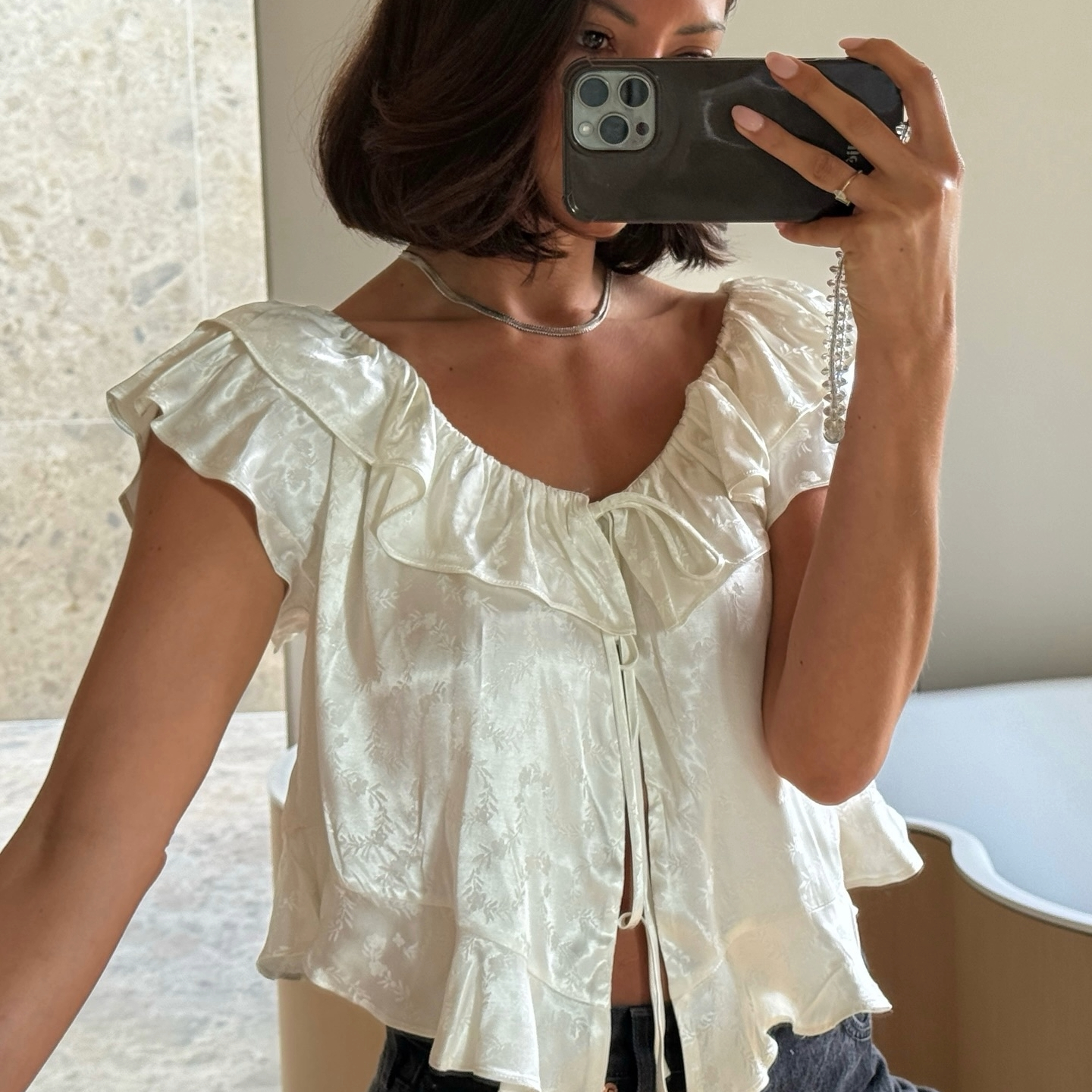 Marianne Smyth in a white silk D&ocirc;en top