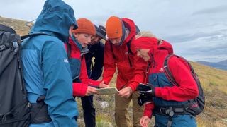 A hiking group consults the map