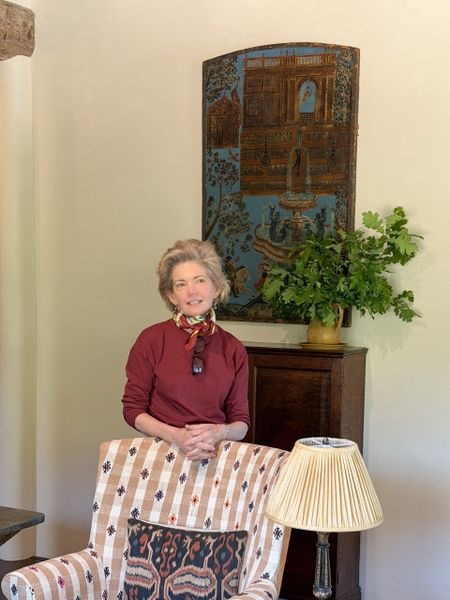 Kate Stamps standing behind an armchair