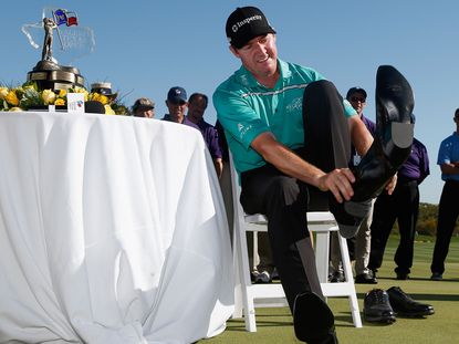 Jimmy Walker dons the winner's cowboy boots at the Valero Texas Open