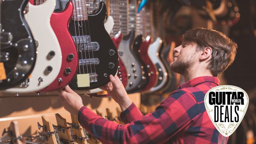 Man in red check shirt in a guitar shop