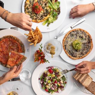 Aerial shot of dinner table with four plates of food