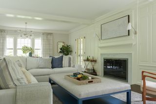 cape cod living room with grandfather clock and green floral armchairs