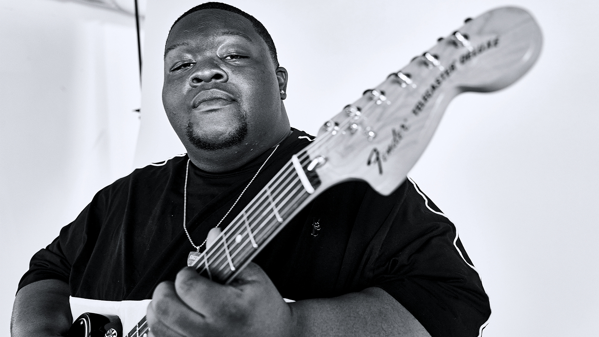 A photo of Christone "Kingfish" Ingram posing with his signature Fender Telecaster Custom