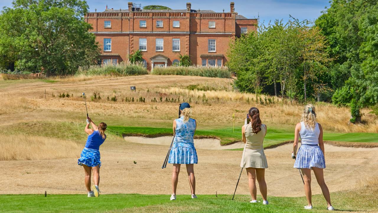 Four female golfers on the tee