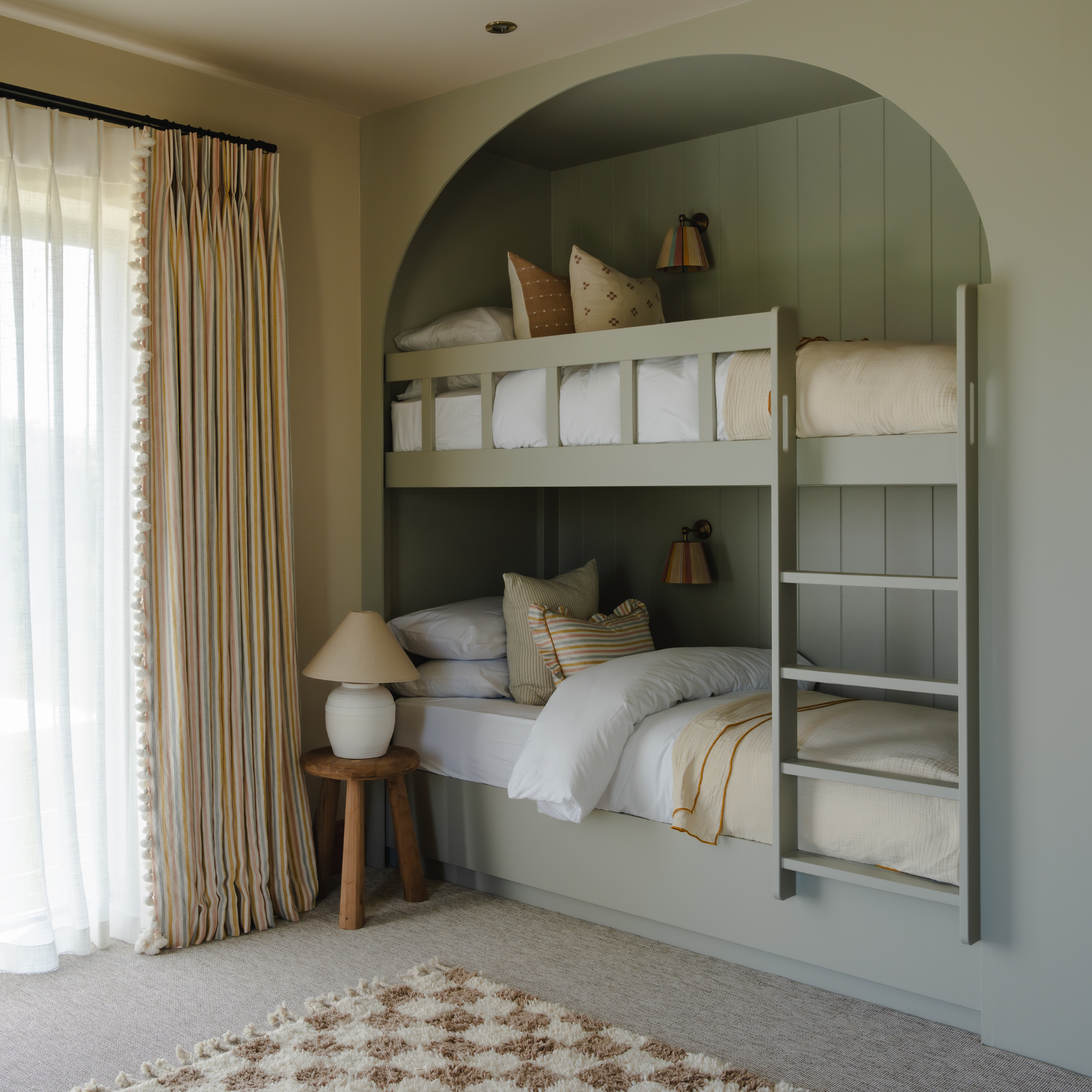 built in bunk beds with arch detail above top bunk
