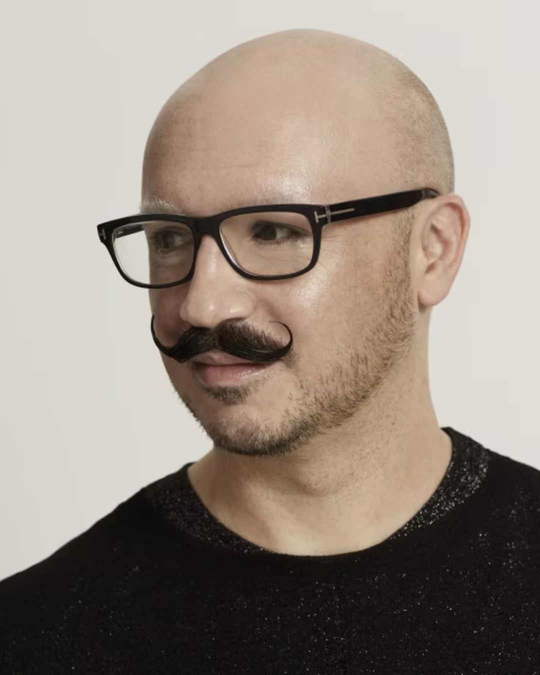 An image of dominic skinner, makeup artist in a black t shirt