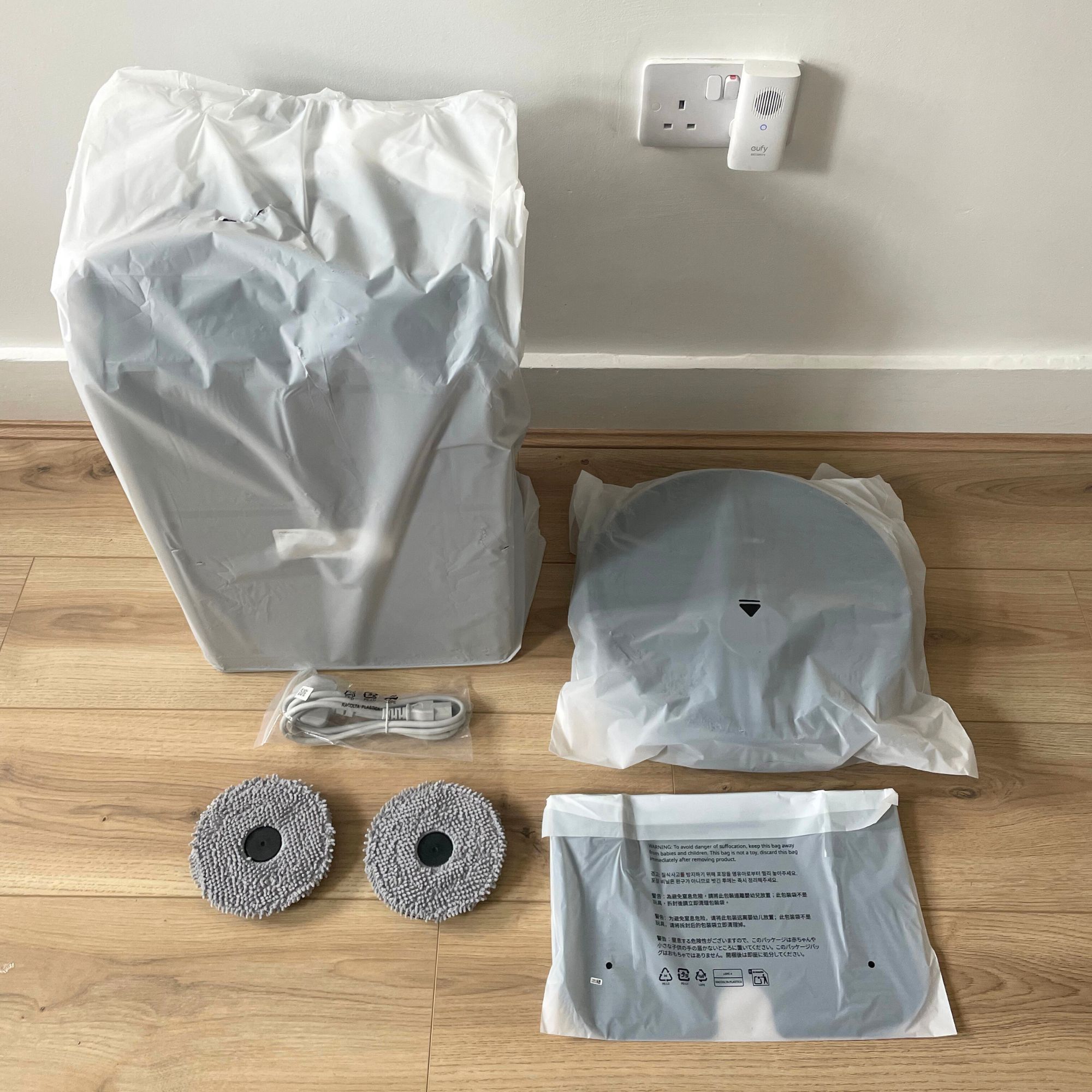 Roborock QV 35S Robot Vacuum components laid out on floor, wrapped in plastic