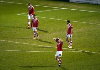 Crewe players react after conceding a goal