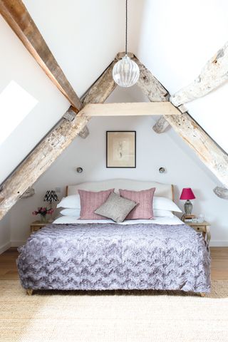 cottage lighting ideas - bedroom in attic with pendant light and beamed ceiling