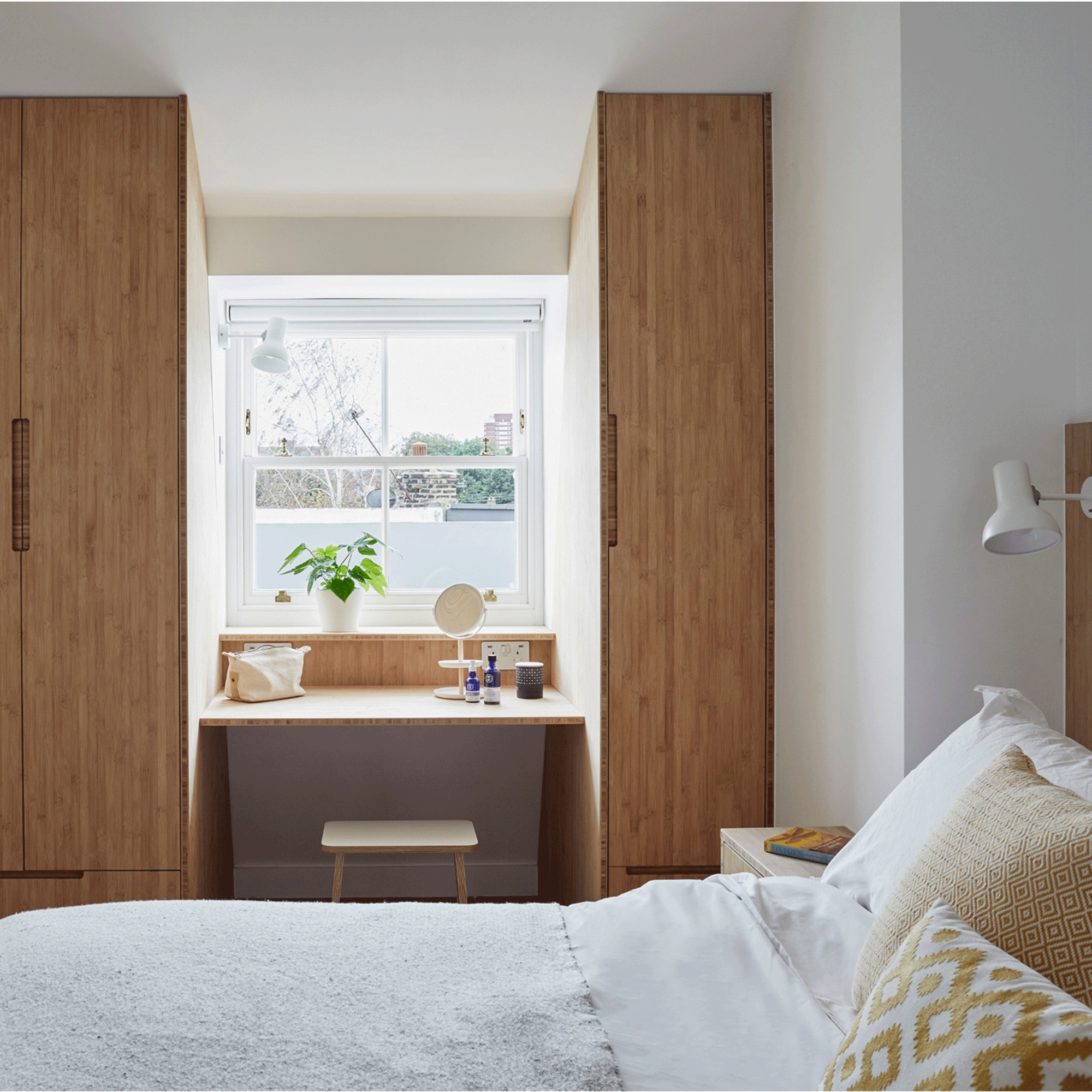Wooden wardrobes in white bedroom