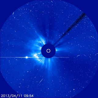 The Solar and Heliospheric Observatory (SOHO) used its coronagraph to capture this image of a coronal mass ejection (the circle of light to the left of the sun) leaving the sun and moving into space. 