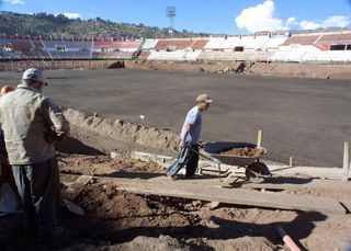 Builders at work during renovations of the Estadio Garcilaso in Cusco in 2004.