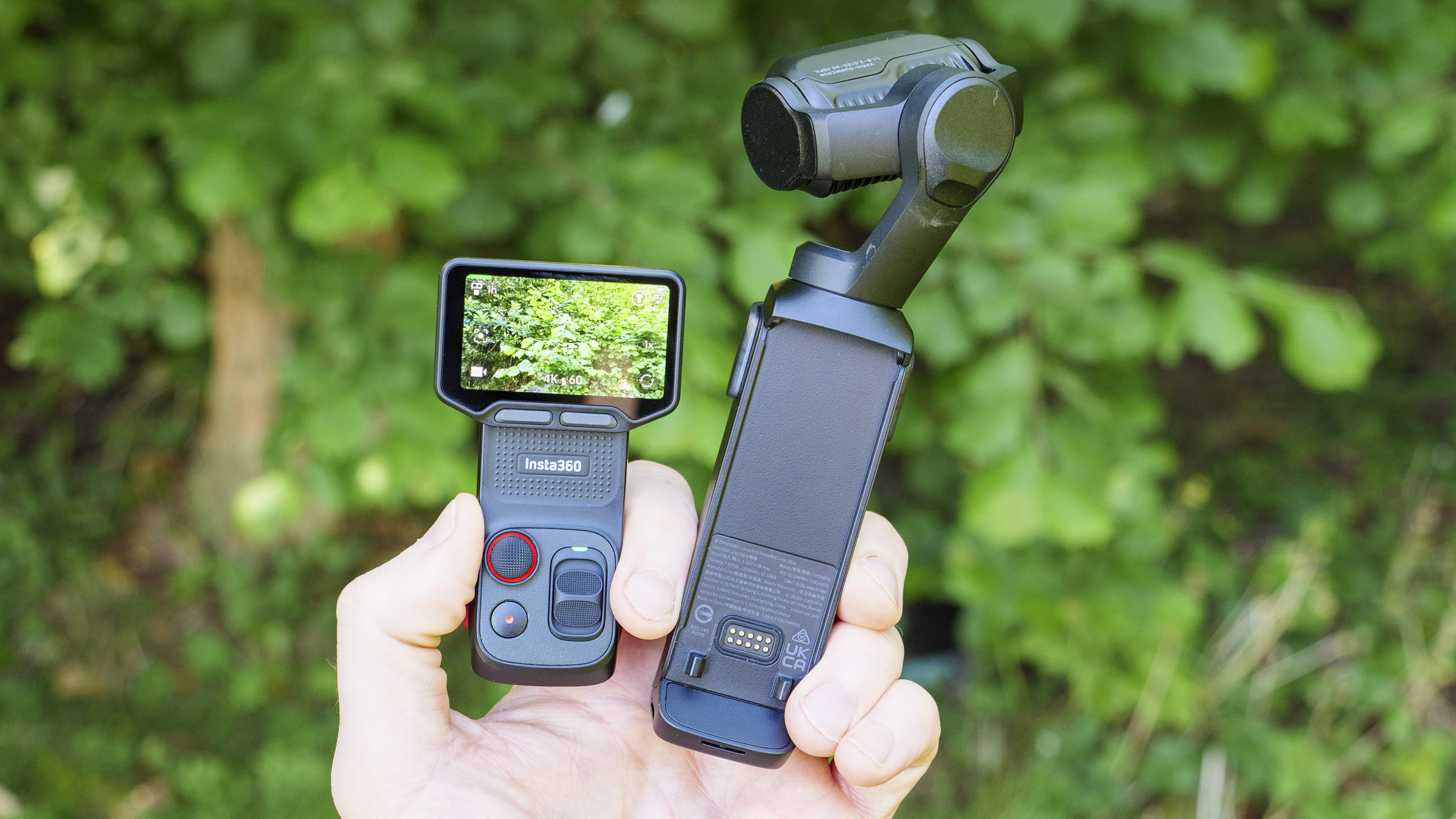 Insta360 Luna Ultra vlogging camera in person's hand, monitor module detached, leafy background
