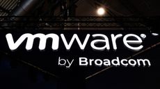 The VMware by Broadcom logo shot against a dark background on the ceiling of an events space.