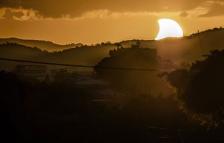 Photographer CJ Armitage of Brisbane, Australia captured this stunning view of the sunset solar eclipse on April 29, 2014 during the first solar eclipse of the year. A partial solar eclipse was visible from most of Australia during the event, with an annular solar eclipse occurring over a remote area in Antarctica.