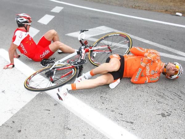 A Cofidis and Euskaltel-Euskadi rider gather themselves after crashing.
