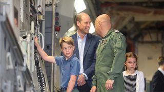 Prince George of Wales raises the ramp on the C17 plane during the visit to the Air Tattoo at RAF Fairford with Prince William