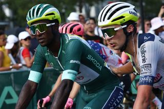 Intermarche - Wanty team's Eritrean rider Biniam Girmay wearing the sprinter's green jersey is assisted by teammates as he cycles past the finish line after crashing in the final kilometers of the 16th stage of the 111th edition of the Tour de France cycling race, 188,6 km between Gruissan and Nimes, southern France, on July 16, 2024. (Photo by Anne-Christine POUJOULAT / AFP)