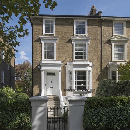 house entrance with white windows and door and front garden