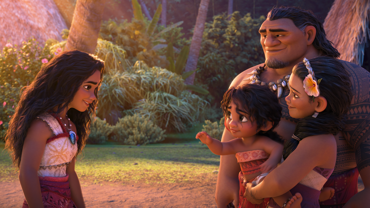 Moana 2 looking at her sister, who is in their mother's arms and beside their father in Moana 2