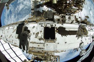 Astronauts Outfitting ISS during spacewalk