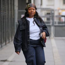 a woman wearing an oversized denim jacket