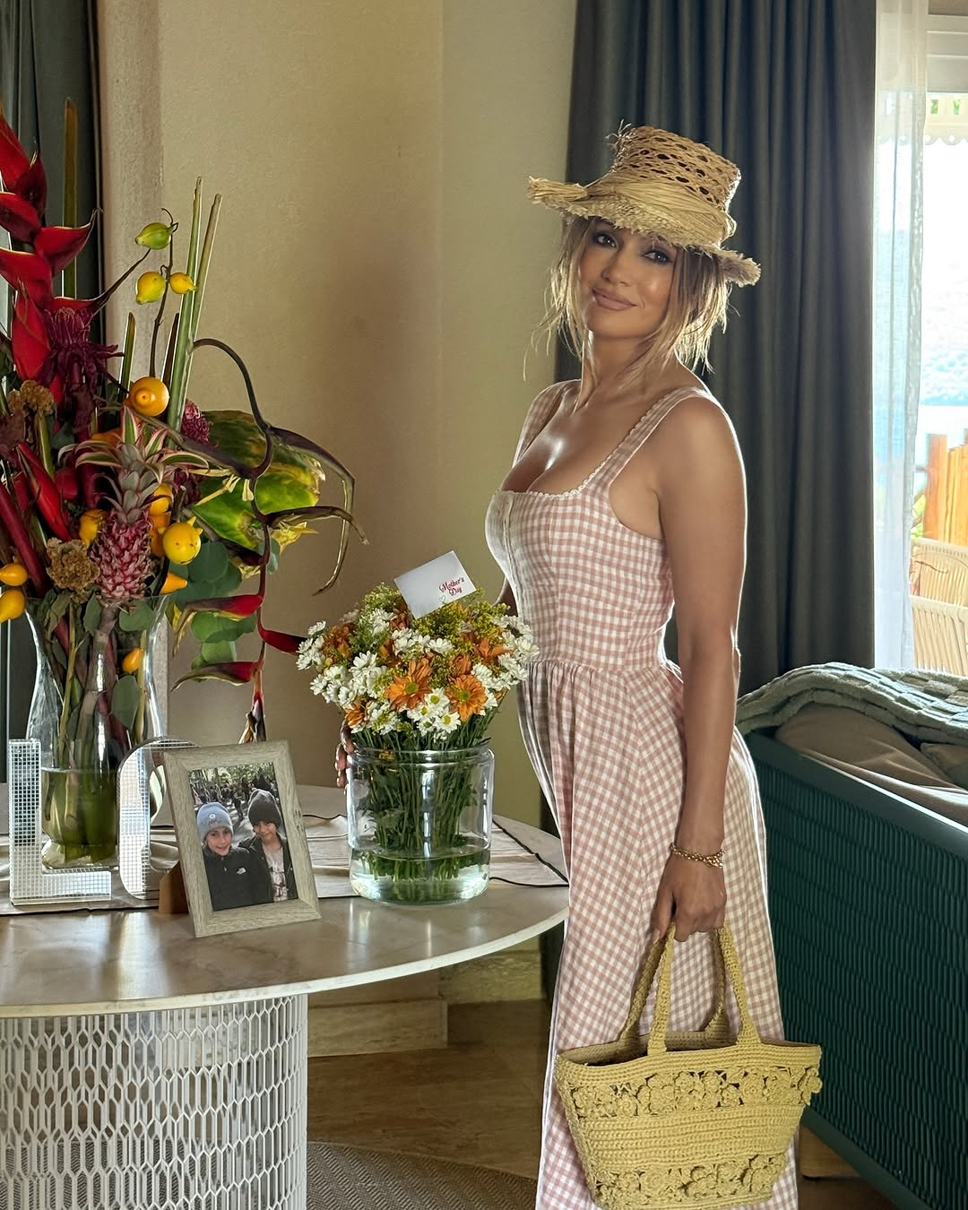 jennifer lopez wears dior wicker accessories and reformation dress on mother's day
