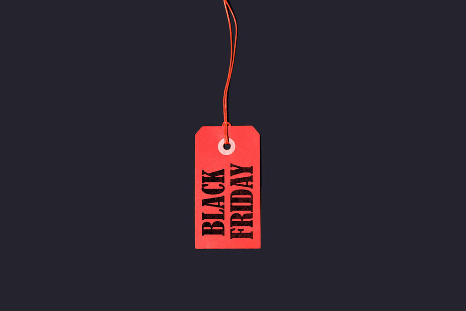 A red product label with Black Friday on it against a black background. 