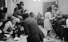 black and white image of people drinking and dancing, from the exhibition 'Bar Stories on Camera' from Magnum Photos and Campari