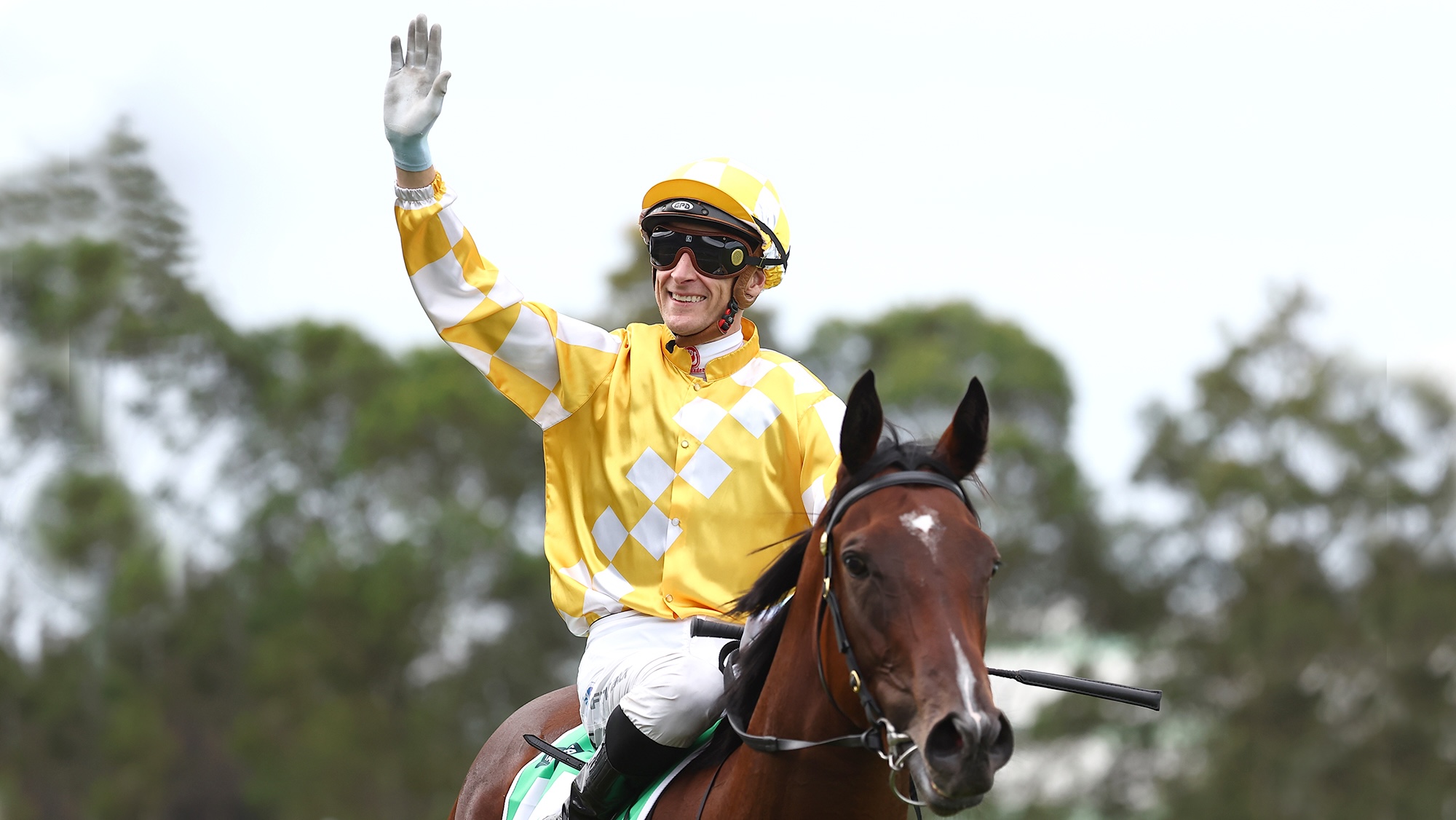 Jockey Blake Shinn waves to the crowd on Lady Of Camelot after a win