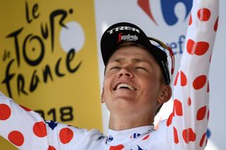 Tom Skujins puts on the polka dot jersey after stage 5 at the Tour de France