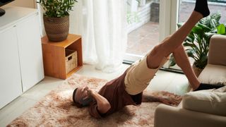 man doing a glute bridge in his living room